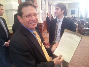 Harvey Kronberg with a Texas House resolution honoring 30 years of the Quorum Report. 